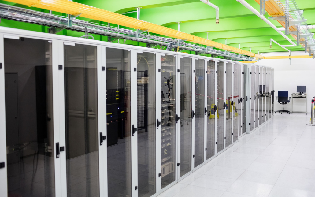 View Of A Large Server Room With White Server Cases