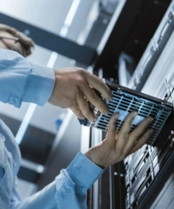 engineer removing a tape drive from a server rack